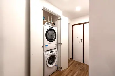 a hallway with a living room with a couch at BOHEMIAN PIGNETO RHOME - 2bdr 2bath - Metro Pigneto connecting in 8 minutes to Colosseum - Near Termini Railway station, La Sapienza Uni, Policlinico Umberto I hospital - Family friendly with baby equipment - Vibrant area - Guest care in 4 languages in Rome