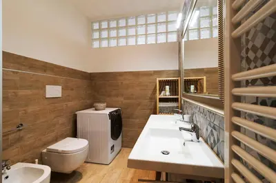 a bathroom with two sinks and a toilet and a mirror at Al Vaticano Roma Suite in Rome