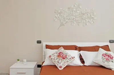 a bedroom with a bed with pillows on it at Domus 68 - Apartment with terrace in Rome