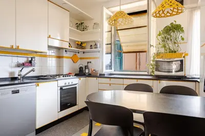 a kitchen with a table and chairs in it at Urbanflat Colosseum in Rome
