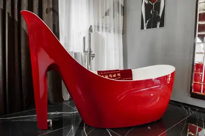 a red high heel shoe sitting on a floor in a bathroom at Suite Tacco 12 in Rome