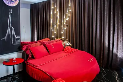 a red bed with red pillows in a bedroom at Suite Tacco 12 in Rome