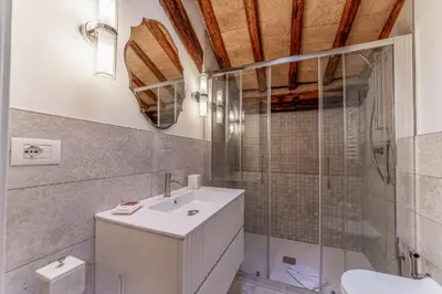 a bathroom with a white sink and a shower at Madama Lucrezia - Fontana di Trevi & Pantheon in Rome