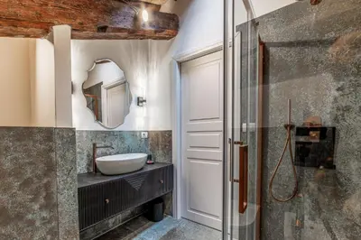 a bathroom with a sink and a mirror at Madama Lucrezia - Fontana di Trevi & Pantheon in Rome