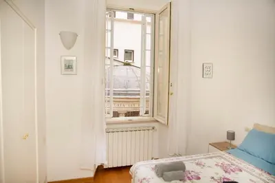 a bedroom with a bed and a window at Tempietto del Carmelo in Rome