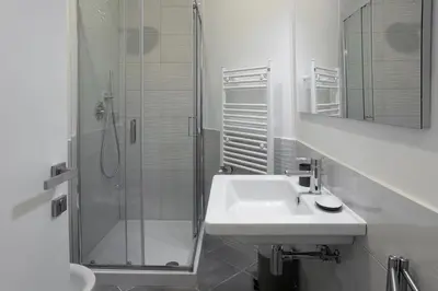 a bathroom with a white sink and a toilet at Centro Roma Giallo - LOCAPPART in Rome