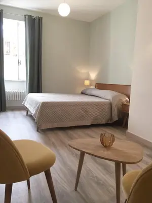 a bedroom with a bed and a table and chairs at Centro Roma Grande - LOCAPPART in Rome