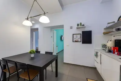 a kitchen and dining room with a table and chairs at Aurora Vatican House - San Pietro in Rome