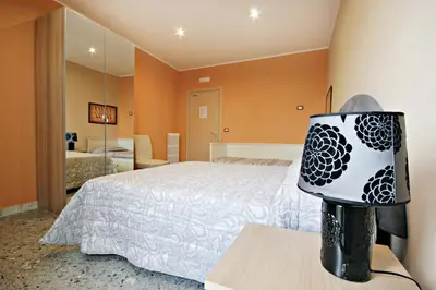 a bedroom with a bed and a lamp on a table at B&B Clelia in Rome