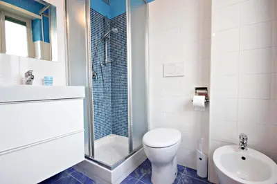 a bathroom with a toilet and a sink and a shower at B&B Clelia in Rome