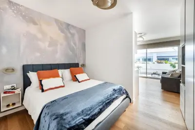 a bedroom with a large bed with orange pillows at Colosseum Luxury suite 26 in Rome