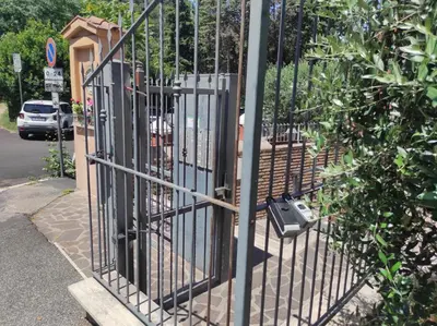 a metal gate with a mailbox on the side of a street at Foro appartament in Rome