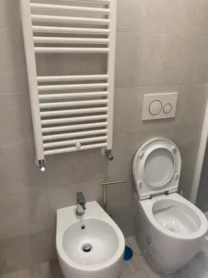 a small bathroom with a toilet and a sink at Michelangelo Luxury Rooms - Colosseo - WiFi in Rome