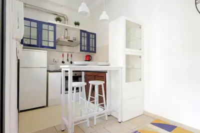 a small kitchen with a counter and stools at Rifugio segreto nel cuore di Roma in Rome
