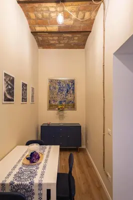 a dining room with a white table and chairs at The Heartbeat of Bohemian Rome in Rome