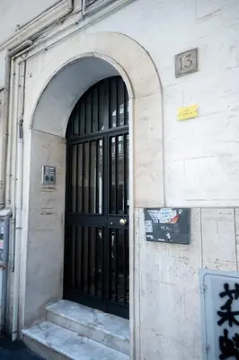 a building with a black door on the side of it at Yellow Pop Apartment - Design e Colore a Roma in Rome
