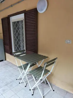 a picnic table and two chairs on a patio at Stefy's House Appio Tuscolano in Rome