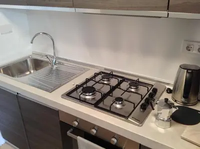 a kitchen with a stove top in a kitchen at St Peter Vatican wonderfull view apartment in Rome