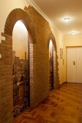 a brick wall with two arches in a room at St Peter Vatican wonderfull view apartment in Rome