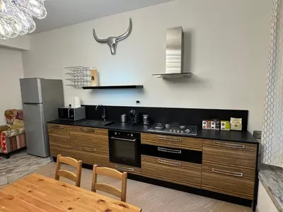 a kitchen with a stove and a table and a refrigerator at Appia 101 Guest House in Rome