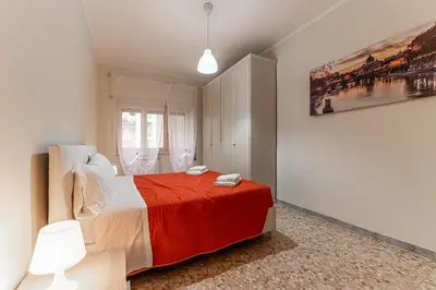 a bedroom with a bed and a painting on the wall at Vacanze Romane - Metro Teano & Wi-Fi in Rome
