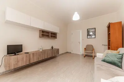 a living room with a tv and a couch at Vacanze Romane - Metro Teano & Wi-Fi in Rome