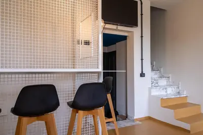 two black chairs in a room with a tv at Livin' San Lorenzo in Rome