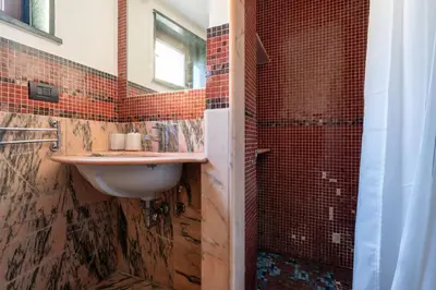 a bathroom with a sink and a shower at Livin' San Lorenzo in Rome