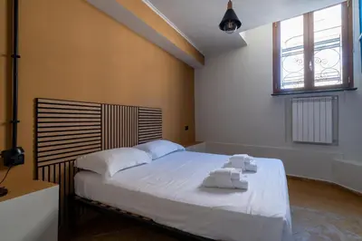 a bedroom with a bed with towels on it at Livin' San Lorenzo in Rome