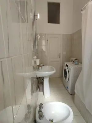 a bathroom with a sink and a washing machine at Rifugio del Quadraro Rome in Rome