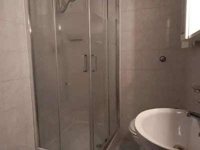 a bathroom with a shower and a toilet and a sink at TravelR's Home in Rome