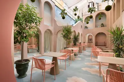 a restaurant with tables and chairs and potted plants at Leon's Place Hotel In Rome in Rome