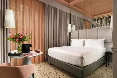 a hotel room with a bed and a table and a chair at Leon's Place Hotel In Rome in Rome
