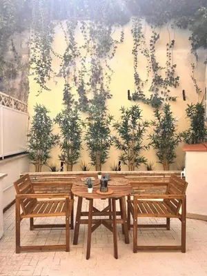 a table and two chairs in front of a wall at Casa Mari Vaticano in Rome