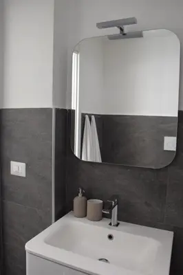 a bathroom with a white sink and a mirror at Casa Mari Vaticano in Rome