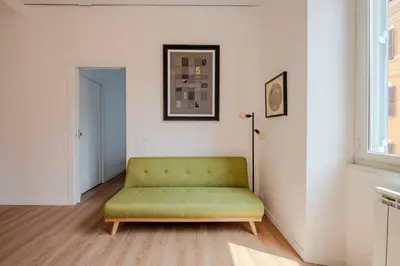 a green couch in a living room with a window at Dante Art Home in Rome