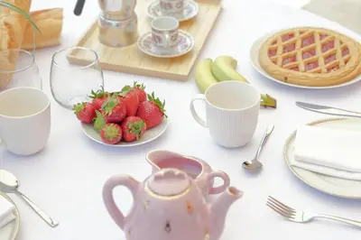 a table with a tea pot and a plate of strawberries at Arte della Medaglia Gallery House in Rome
