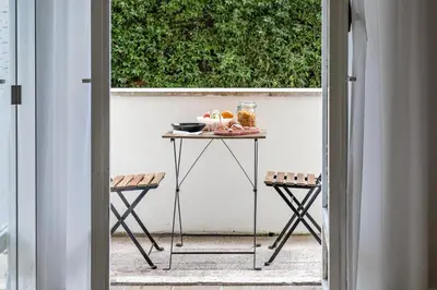 a small table on a patio with two chairs at Vatican LeM collection in Rome