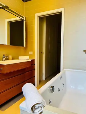 a bathroom with a tub and a sink and a mirror at Borgo Pio Suite Apartment in Rome
