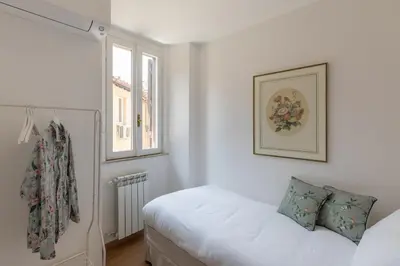 a white bedroom with a bed and a window at iFlat Historic Charm & Comfort by Piazza Navona in Rome