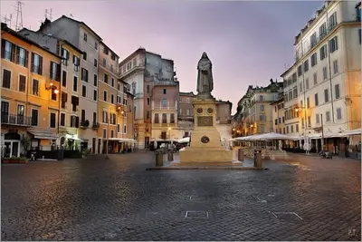 a statue in the middle of a city with buildings at Loft Navona in Rome