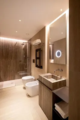 a bathroom with a sink and a toilet and a mirror at Palazzo 4 Fontane 12 in Rome