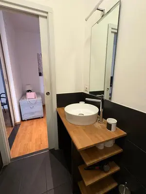 a bathroom with a sink and a mirror at Loft in Colosseum, style in the heart of Rome! in Rome