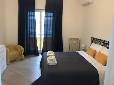 a bedroom with a bed with two towels on it at San Peter-Vatican Way in Rome