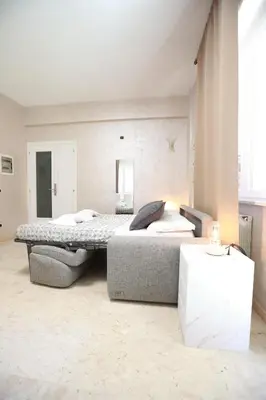 a bedroom with a large bed and a couch at Unique Stay Tiburtina in Rome