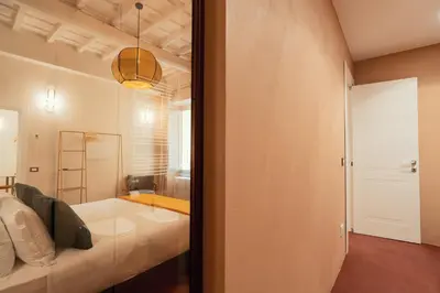 a living room with a bed and a glass door at Casa Mia Navona in Rome