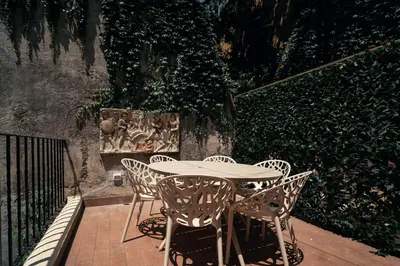 a white table and chairs on a patio at Casa Mia Navona in Rome