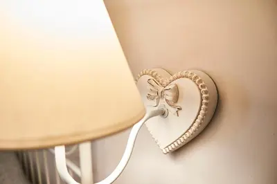 a heart shaped decoration on a wall next to a lamp at Ale & Niki's Home in Rome