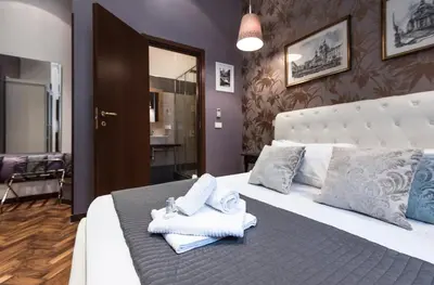 a hotel room with a bed with towels on it at Vite Suites Guest House in Rome