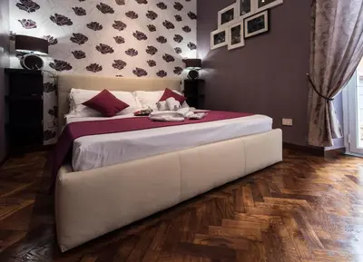 a bedroom with a large white bed in a room at Vite Suites Guest House in Rome